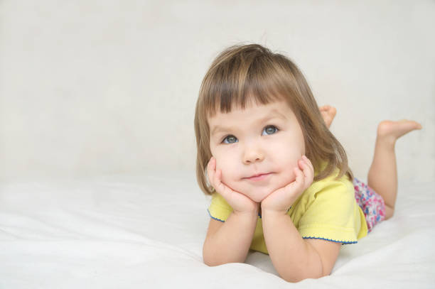 istock dreaming girl lying on bed smiling happy 639123340