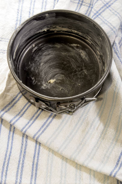 with butter greased baking tray on a kitchen towel