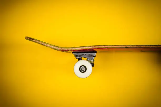 view of the skateboard on a yellow background