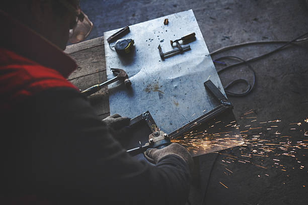istock Young man grinding metal overhead shot 639124822
