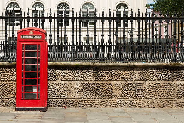 London Phone Booth London, United Kingdom - June 24, 2016: A red London phone booths late in the day in Trafalgar Square. british telecom photos stock pictures, royalty-free photos & images