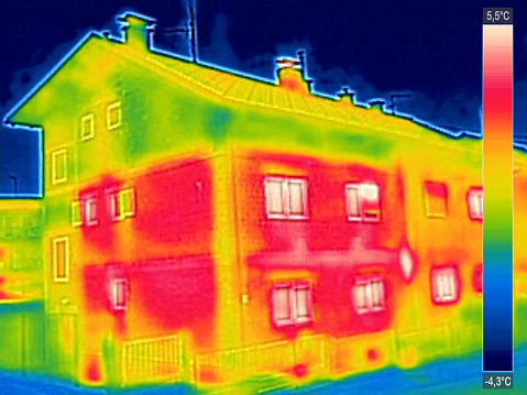 Infrared thermovision image showing lack of thermal insulation on House with or without facade
