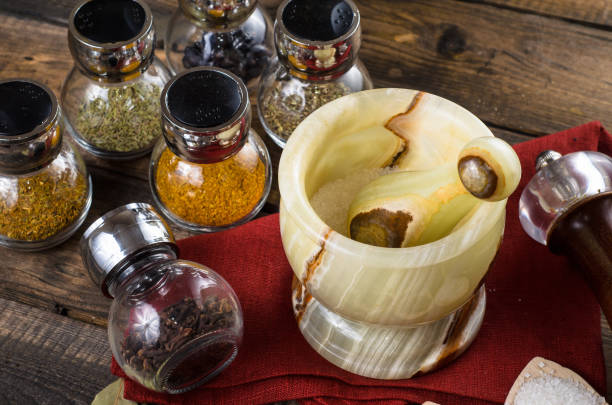 spices in Jar with mortar on a wodeen background