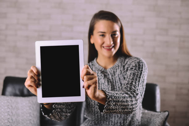 istock Happy girl showing a tablet screen 639129740