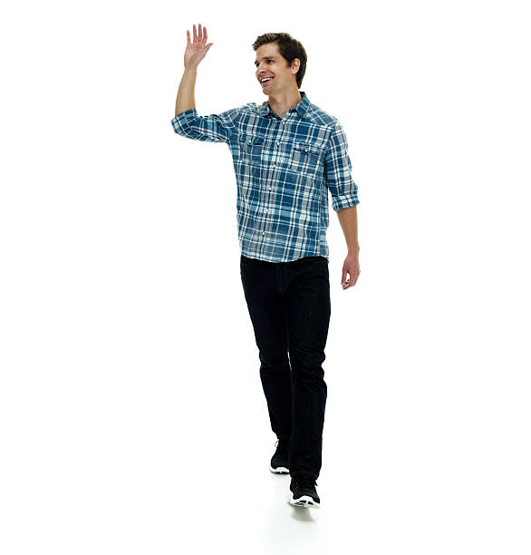 istock Cheerful man waving hand and walking 639132814