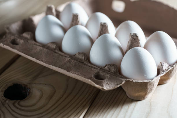 istock opened cardboard egg box with white eggs on a wooden 639137058