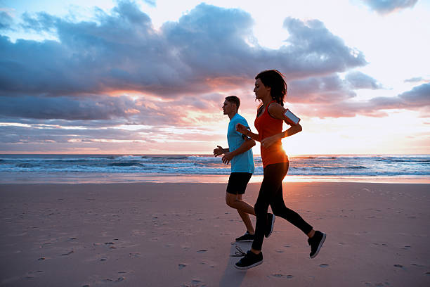 istock Young couple running at Sunrise 639138578
