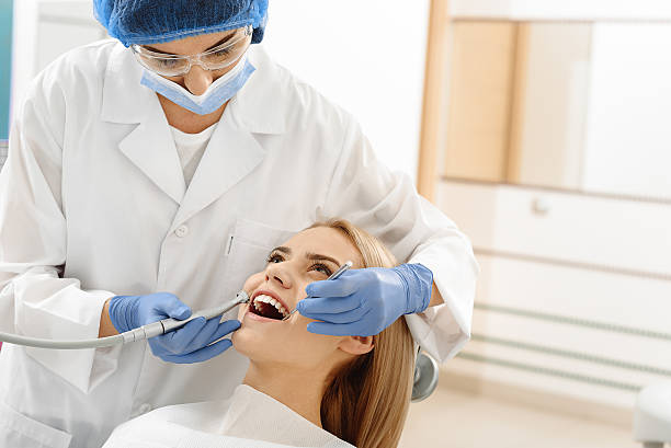 istock Odontologist drilling in mouth of client 639141956