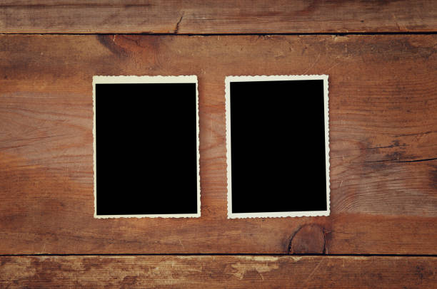 istock blank photo frames on wooden background 639142752