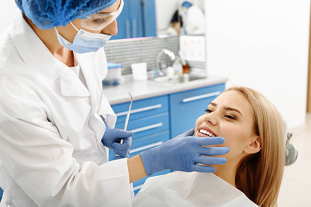 istock Stomatologist checking oral cavity of client after treating teeth 639142786