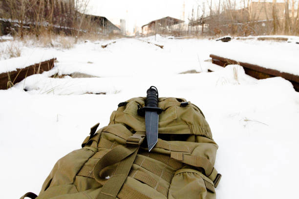 Tactical knif on sand back pack. Tactical knif on sand back pack. Military knif stock pictures, royalty-free photos & images