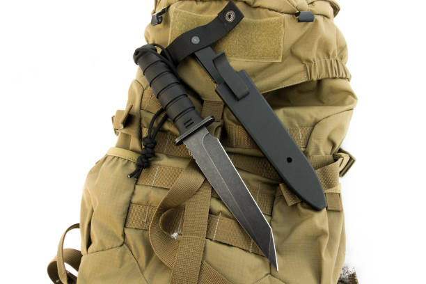 istock Combat knife on sand military back. Black irom. 639144502