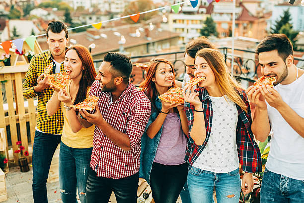 istock Eating pizza at a party on the roof 639144708