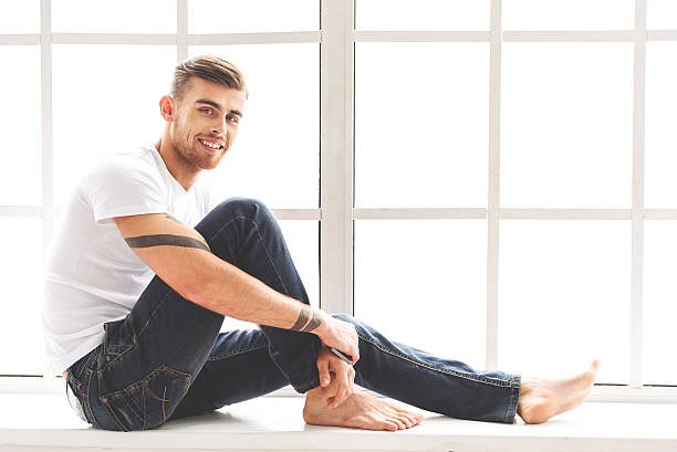 istock Joyful guy sitting near window 639147910