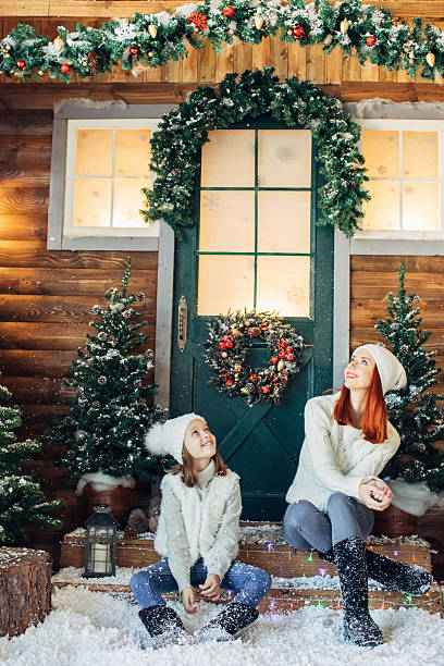 istock Mom and her daughter playing with snow 639149678