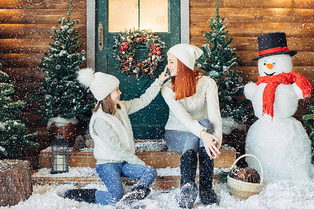 istock Mom and her daughter playing with snow 639151098