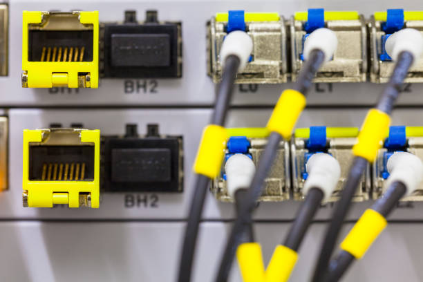 Equipment of radio base station close-up. Internet. Communication. Network Equipment of radio base station close-up, blue and yellow optic patch cords. Internet. Communication. Network computer plan fiber optic engineer stock pictures, royalty-free photos & images