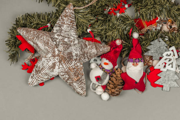 istock Christmas ornaments and rustic star placed in smooth grey background 639151612