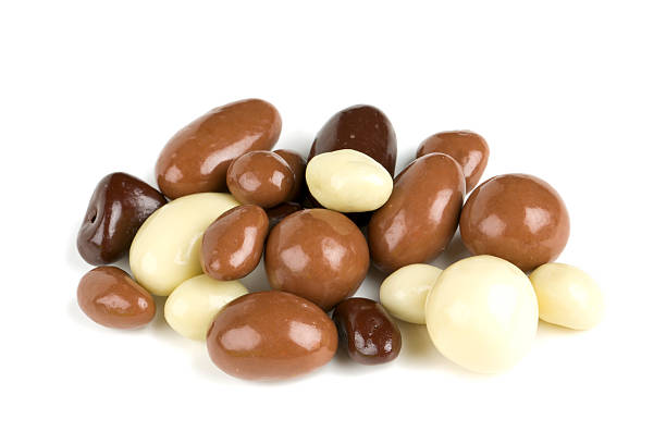 istock chocolate covered nuts and raisins isolated on white 639151972