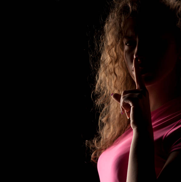 istock unknown woman with the face in the shadow 639156346
