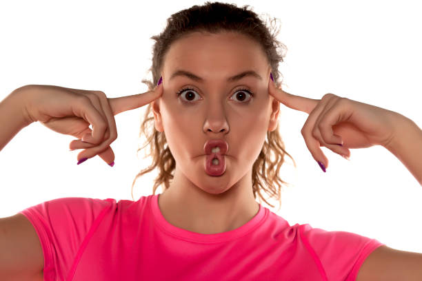 istock funny young woman making fish face 639156922
