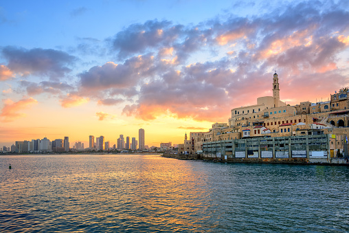 Old town of Jaffa and the modern skyline of Tel Aviv city on sunrise, Israel