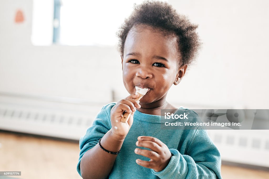 yogurt is great for kids toddler and healthy breakfast Eating Stock Photo