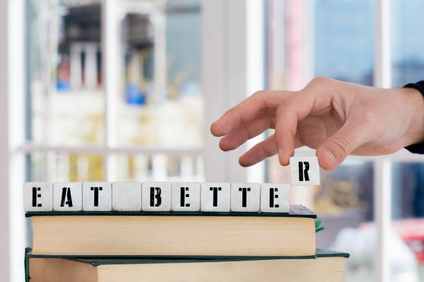 istock EAT BETTER Concept , Hand with alphabet blocks 639157916