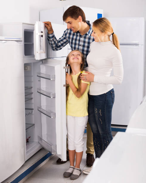 family selecting refrigerator - three different refrigerators imagens e fotografias de stock