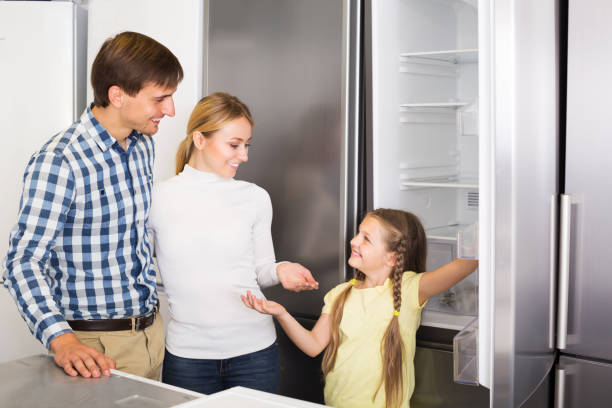 family selecting refrigerator - three different refrigerators imagens e fotografias de stock