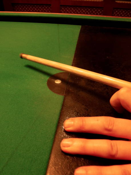 istock Bar Billiards table with person holding cue stick 639162370