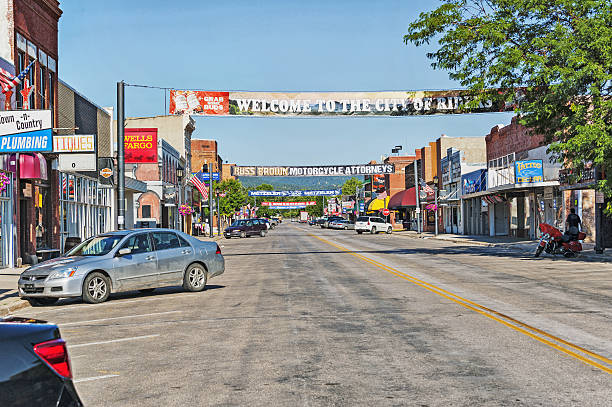 Sturgis, South Dakota, USA - July 18, 2016: This view of main street in Sturgis South Dakota the motorcycle capital of the United States every year with their annual raley, this street current has many banners across the street and even a few cars parked on the street within a few days with the thousands of motorcycles arrival the street will be crowded with motorcycles, the street has many signs and placards that appear to be geared to the bikers that are anticipated to start arriving soon, it was very interesting to visit this community just prior to the upcoming raley to see that this is for most of the year a smaller community but on this July day it was quiet and waiting in anticipation.