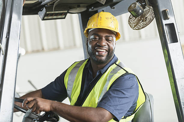 istock African American man driving a forklift 639165408