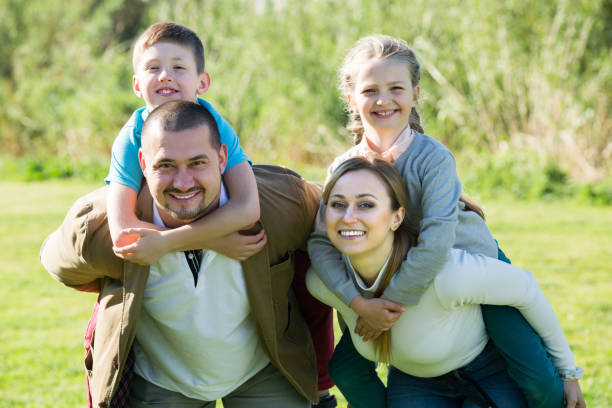 istock Parents holding kids on shoulders 639165606