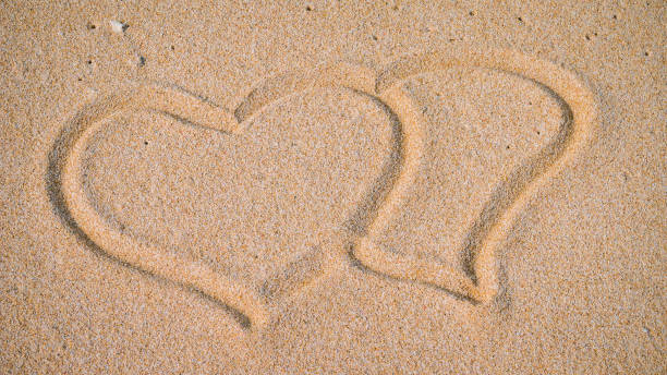 istock Two Hearts in the Sand on the Beach 639165854