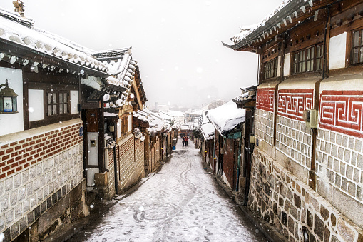 the famous alleyway in bukchon hanok village taken during a snow storm. Seoul, South Koreathe famous alleyway in bukchon hanok village taken during a snow storm. Seoul, South Korea