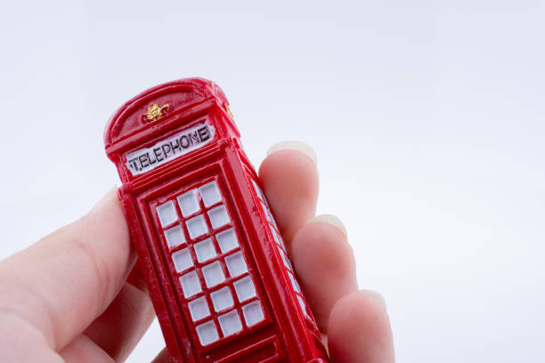 istock Hand holding a phone booth on a white background 639168150