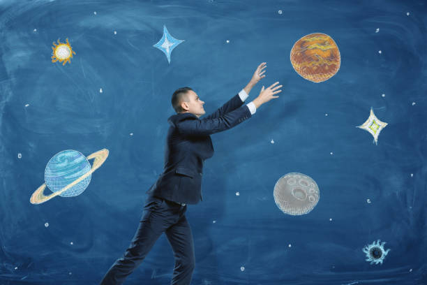 istock Businessman on blue chalkboard background trying to grasp a drawn 639173502