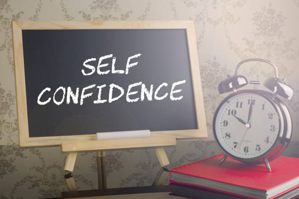 istock self Confidence on blackboard with flare and clock. 639174566
