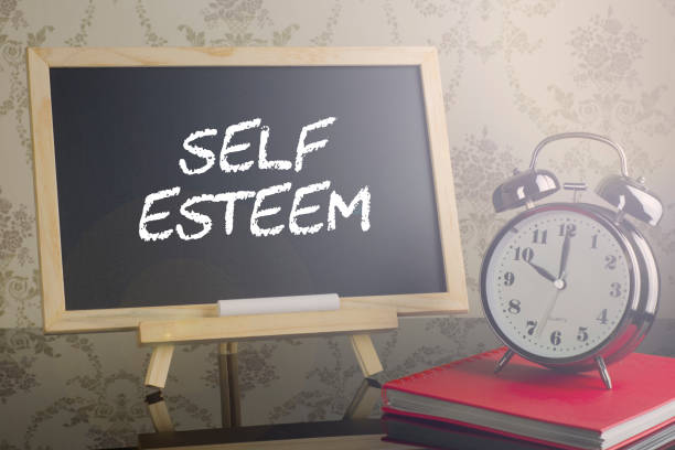 istock Self Esteem on blackboard with flare and clock. 639174614