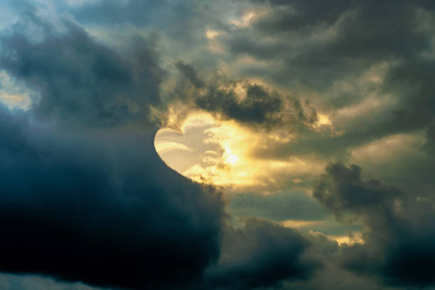 Sunlight shine from the sky through the clouds as heart shape in evening