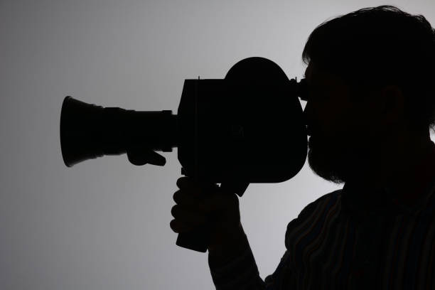 istock Silhouette bearded Man Movie Camera aside 639182832