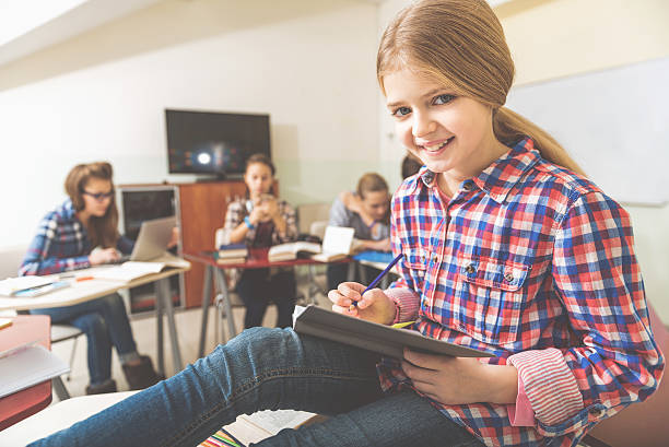 istock Happy smiling girl in classroom 639183772