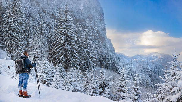 nature photographer at winter in front of hohenschwangau - wetterstein mountains bavaria mountain forest imagens e fotografias de stock