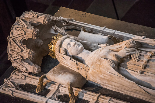 Roskilde, Denmark - January 21, 2017: The beautiful sarcophagus of Queen Margrethe I was placed in Roskilde cathedral in 1423. It shows a life-size alabaster sculpture of the queen and is beautfully decorated with alabaster figures of evangelists, saints and bishops. The sarcophagus is placed behind the high alter of the cathedral.