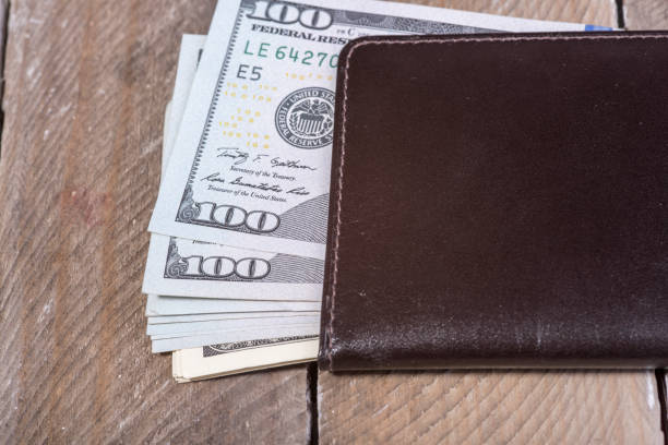 istock wallet full of dollars 639192736