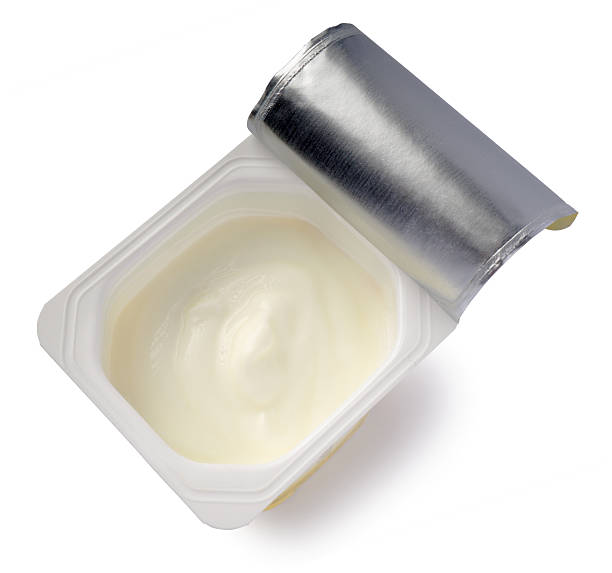 istock Yogurt in white plastic pot from above on white background 639193020