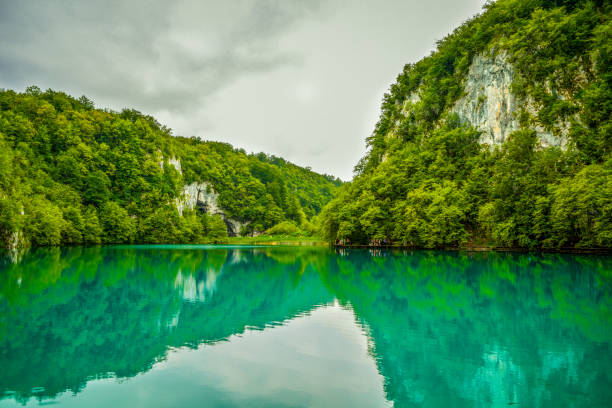 istock Cliff reflections in turquoise color lake on a cloudy day 639193462