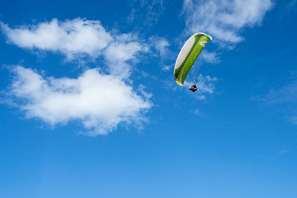 istock Paraglider airborne over sky 639196802