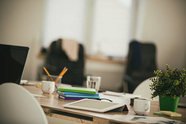 istock Messy table in modern office with digital tablet 639198028